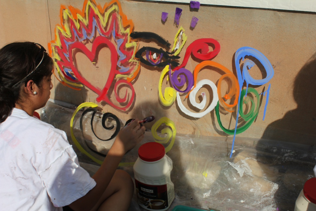 Camper painting tempera on plexiglass. Painting has a flamed valentine, an eye, and multicolored swirls.